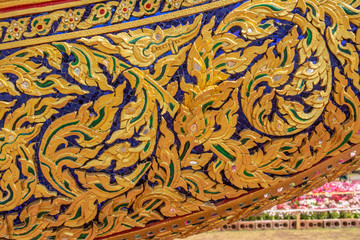 Thai art, carvings using gold color on the decorative plants on the royal ceremonies boat.