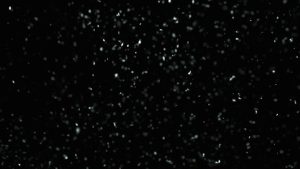 Winter Snow falling on black background in 4K. Slow Motion at 1000 fps.