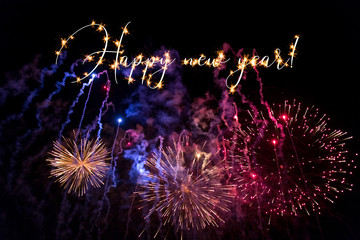 Happy New Year sparkling text with fireworks background. 