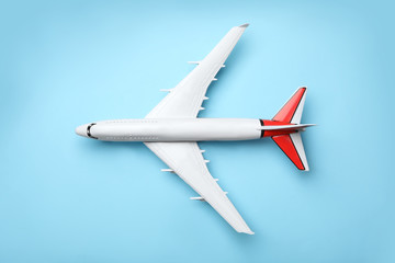 Top view of toy plane on blue background. Logistics and wholesale concept