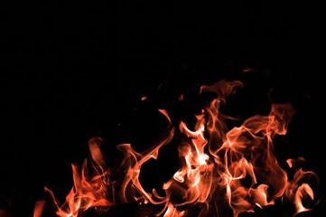 Fototapeta na wymiar Bonfire on a black background. Fire pattern. Tongues of flame on black isolated background