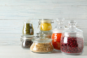 Different types of legumes and cereals on wooden table. Organic grains