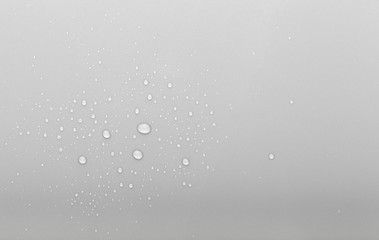 Drops of water on a color background. Selective focus. Gray