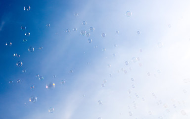 Soap bubbles fly in the blue sky