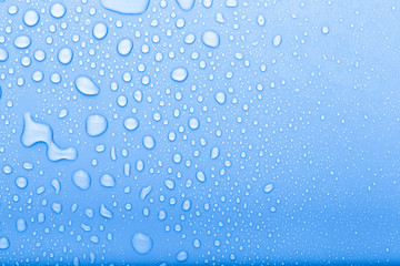 Drops of water on a color background. Selective focus. Blue. Toned
