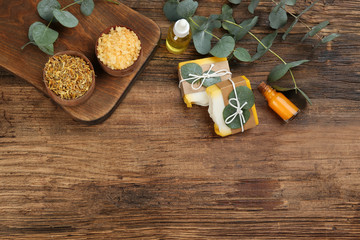 Flat lay composition with natural handmade soap on wooden background. Space for text