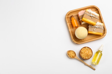 Natural handmade soap and ingredients on white background, top view