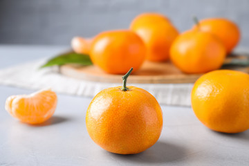 Fresh ripe tangerine on light table, closeup