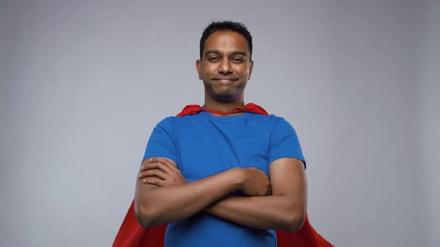 super power and people concept - happy smiling indian man in red superhero cape with crossed arms showing thumbs up over grey background