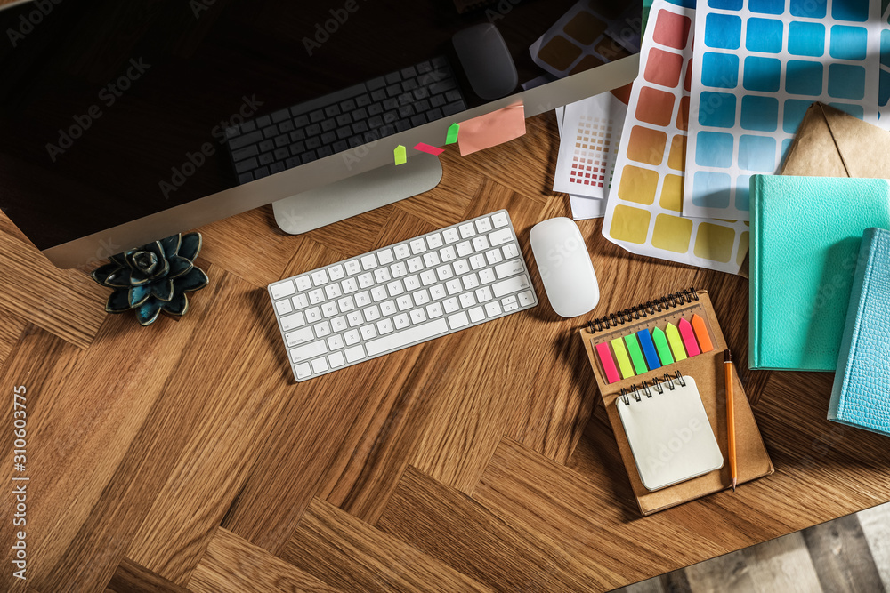 Fototapete designer's workplace with modern computer and color palettes, flat lay. space for text