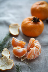 ripe peeled mandarin on a gray background, star anise. For calendar, background