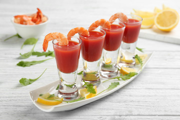 Shrimp cocktail with tomato sauce on white wooden table
