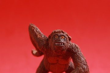 orangutan shaped plastic toy in color background