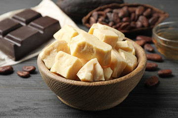 Organic cocoa butter on black wooden table, closeup