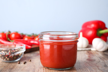 Delicious fresh tomato sauce on wooden table, closeup
