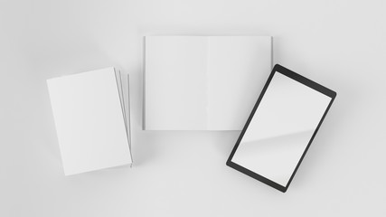 Top view of open and closed books with tablet