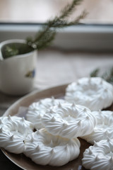 Pavlov’s round white cake on a plate on a linen tablecloth, near the window. For calendar, cover, posters.