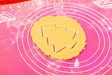 Dough in the form of a Christmas tree on a cooking table