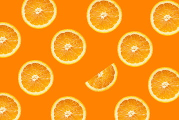 Citrus fruit pattern. Orange slices isolated on an orange background.
