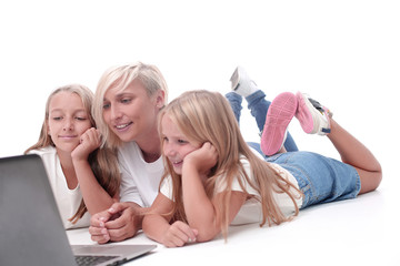 mom and daughters watching their favorite video on a laptop