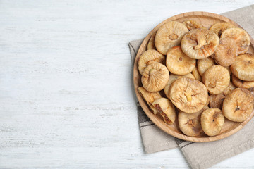 Tasty dried figs on white wooden table, top view. Space for text