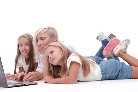 close up. mom and daughters watching a movie on a laptop