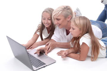 close up. mom and daughters watching a movie on a laptop