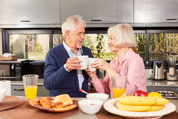 Senior couple is drinking cup of coffee at breakfast