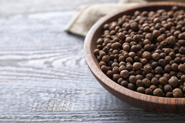 Peppercorns on light grey wooden table, closeup