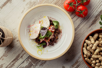 Caucasian Eastern European cuisine. Georgian restaurant salad. The photograph lay flat on the table.