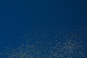 Christmas Gold glitter on blue background. Holiday abstract texture