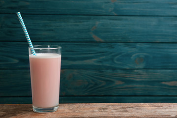 Protein shake on wooden table, space for text