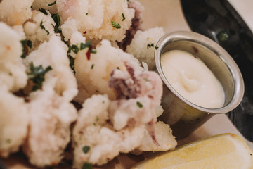 del place of calamari with slice of lemon and mayonnaise