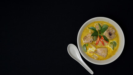 Top view of Thai chicken green curry on black desk background