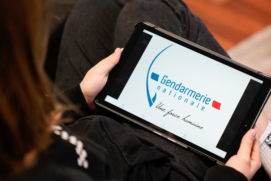 Gendarmerie French Police Sign Logo Screen Tablet Hands Young Woman In Home Sofa France