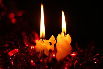 White candles on the table on Christmas night with colorful bokeh lights