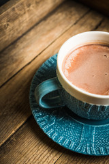 Cup of hot chocolate in winter decorations on the rustic background. Selective focus. Shallow depth of field.