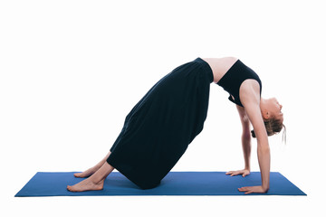 Photo of slim young woman doing yoga wheel pose