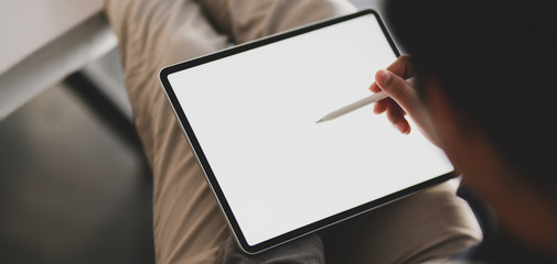 Cropped shot of young man using blank screen tablet