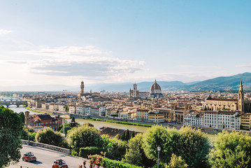 Fototapeta na wymiar Panorama of a beautiful European city in spring. Roofs of houses and domes in Florence Italy. Travelling Europe