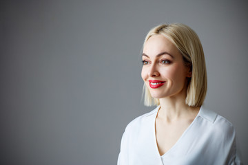 Portrait of beautiful adult woman in white blouse.