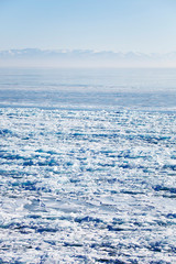 Ice near Listvyanka village. Lake Baikal winter landscape