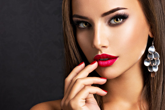 seductive woman with dark brown eye makeup and bright red lips and nails  Stock Photo | Adobe Stock