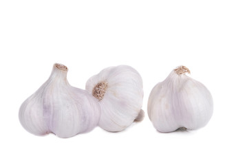 group of three fresh and raw garlic isolated on white background