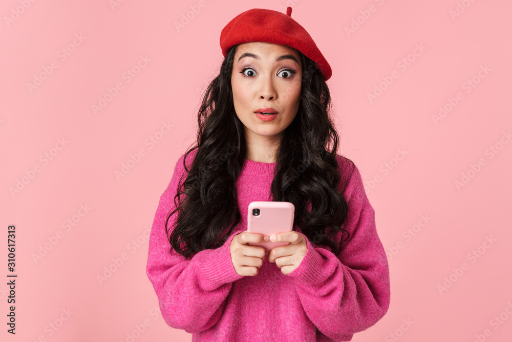 Poster image of surprised beautiful asian girl expressing wonder and holding smartphone