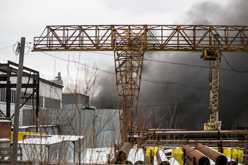Naklejka premium fire at work, storage facilities are burning, firemen are working