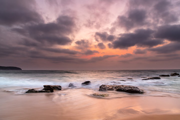 Fototapeta na wymiar Summer Sunrise with Smoky Haze and Clouds at the Seaside