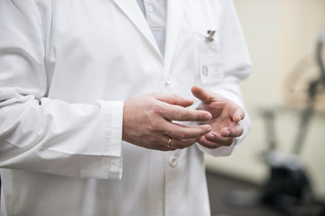 hands of a doctor in a coat talking with a patient