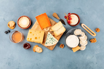 Cheese variety, shot from above. An assortment of different cheeses, a flat lay on a slate background with a place for text
