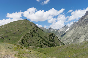 Fototapeta na wymiar Panorama with mountains and blue sky - Cloudy sky over Italian mountain